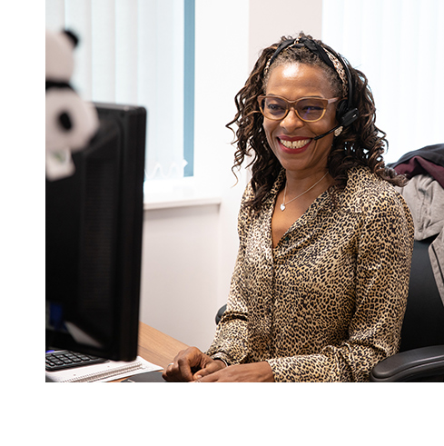 A smiling iLECSYS employee answering the telephone